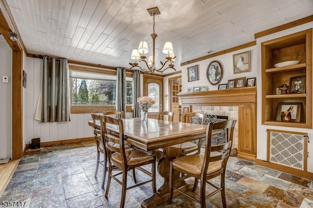 2 Troll Ln, Rockaway Twp, NJ 07866 - dining room featuring built in shelves, stone tile flooring, wooden ceiling, a chandelier, and baseboards