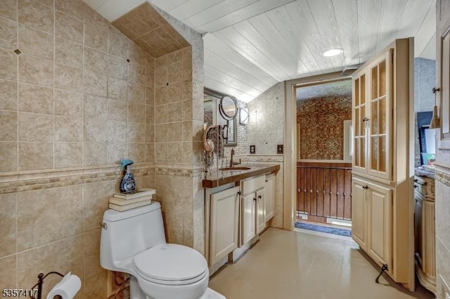 2 Troll Ln, Rockaway Twp, NJ 07866 - bathroom featuring finished concrete flooring, toilet, tile walls, vanity, and lofted ceiling