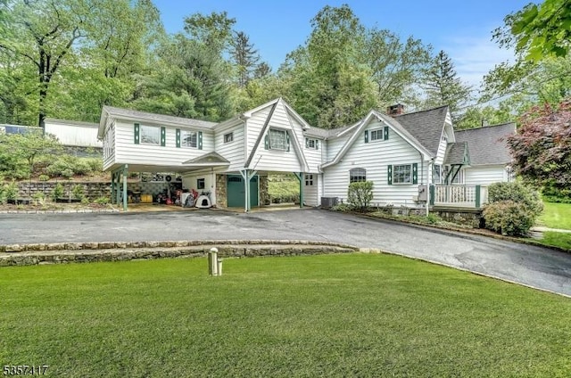 2 Troll Ln, Rockaway Twp, NJ 07866 - view of front facade featuring asphalt driveway, a front lawn, a chimney, and a carport