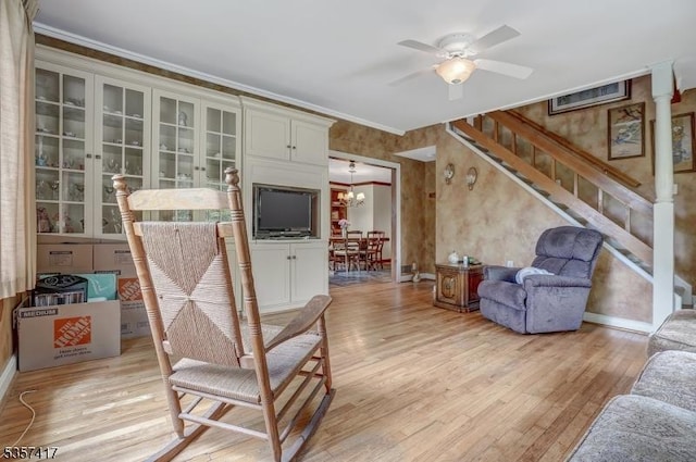 2 Troll Ln, Rockaway Twp, NJ 07866 - living area with light wood-style flooring, ceiling fan, stairway, a chandelier, and crown molding