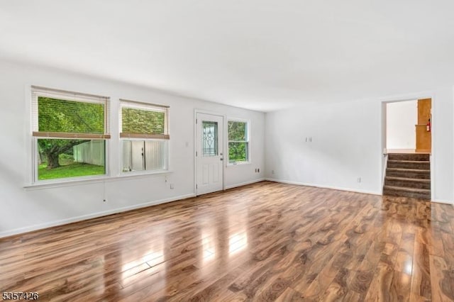 10 Hunts Mill Rd, Clinton Town, NJ 08809 - unfurnished living room featuring wood finished floors, stairway, and baseboards
