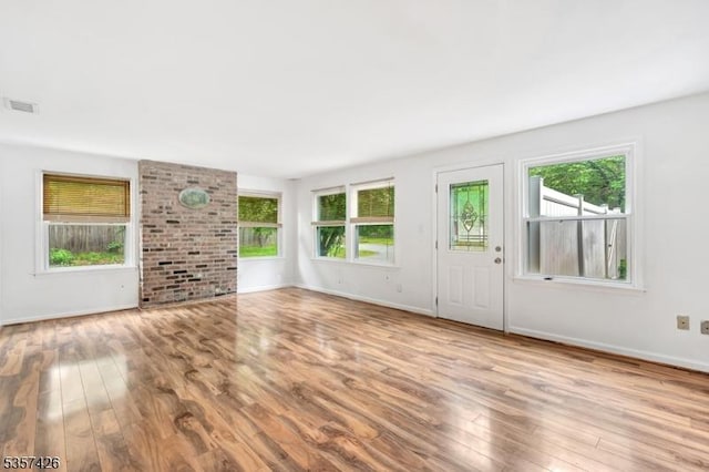 10 Hunts Mill Rd, Clinton Town, NJ 08809 - unfurnished living room featuring plenty of natural light, wood finished floors, and baseboards