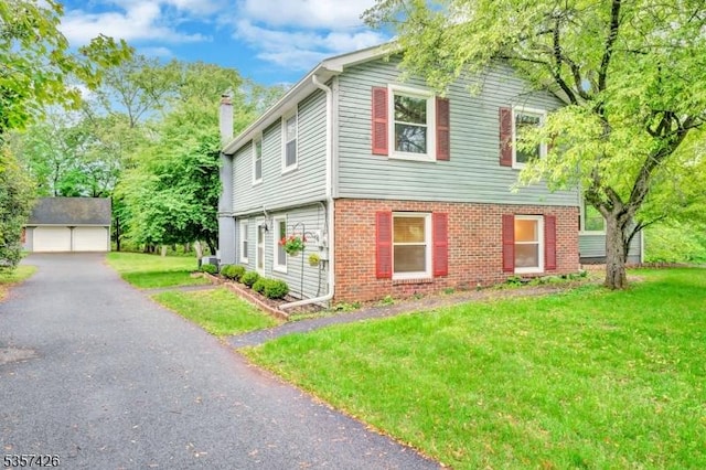 10 Hunts Mill Rd, Clinton Town, NJ 08809 - view of front facade with a detached garage, an outbuilding, brick siding, and a front yard