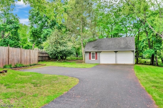 10 Hunts Mill Rd, Clinton Town, NJ 08809 - view of yard with a detached garage, view of wooded area, and an outbuilding