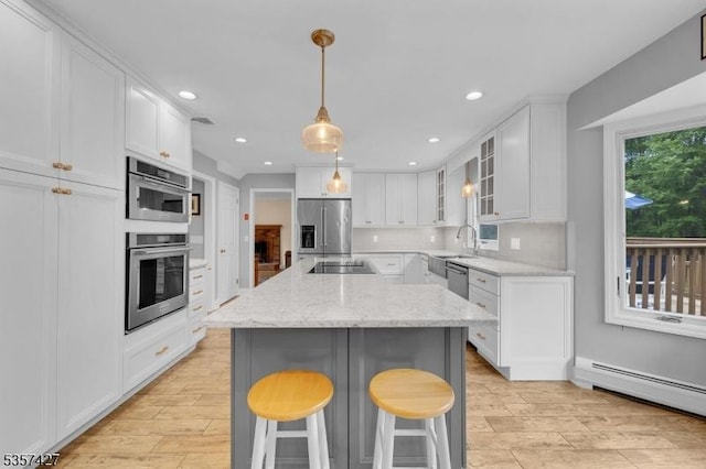 19 Bennington Dr, Mount Olive Twp, NJ 07836 - kitchen featuring appliances with stainless steel finishes, a baseboard radiator, light wood-type flooring, white cabinetry, and recessed lighting