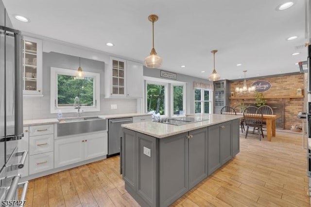 19 Bennington Dr, Mount Olive Twp, NJ 07836 - kitchen with stainless steel appliances, a sink, gray cabinets, white cabinets, and light wood-type flooring