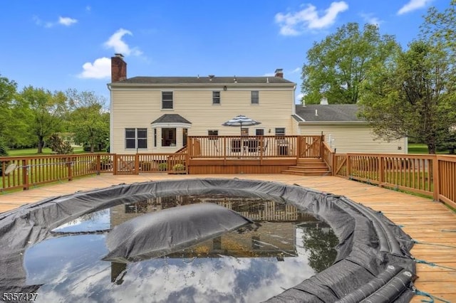 19 Bennington Dr, Mount Olive Twp, NJ 07836 - rear view of house featuring a deck and a chimney