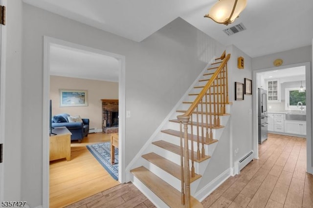19 Bennington Dr, Mount Olive Twp, NJ 07836 - staircase featuring a baseboard radiator, wood finished floors, and baseboard heating