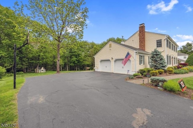 19 Bennington Dr, Mount Olive Twp, NJ 07836 - view of home's exterior with a chimney, driveway, a garage, and a yard