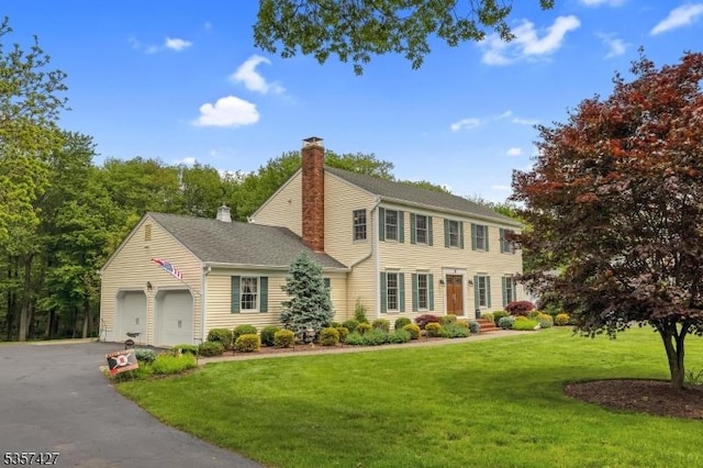 19 Bennington Dr, Mount Olive Twp, NJ 07836 - colonial house featuring a chimney, a front lawn, a garage, and asphalt driveway
