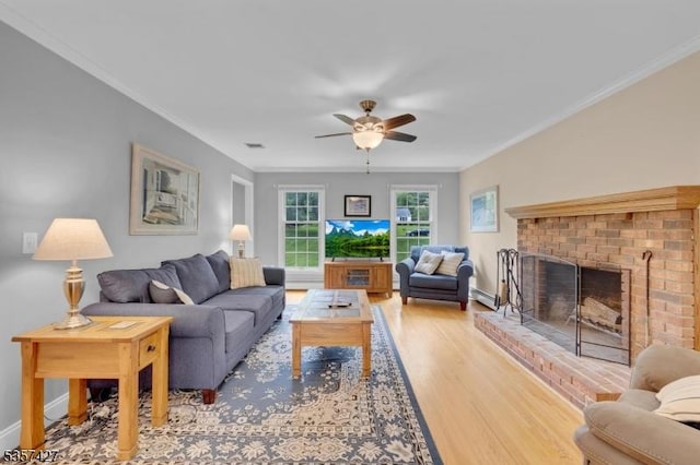 19 Bennington Dr, Mount Olive Twp, NJ 07836 - living room featuring ceiling fan, baseboard heating, ornamental molding, wood finished floors, and a brick fireplace