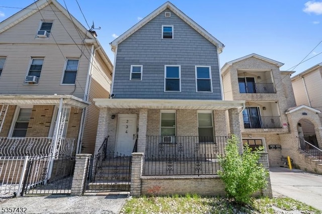 234 Lt Glenn Zamorski Dr, Elizabeth City, NJ 07206 - view of front of house with a porch, brick siding, a fenced front yard, and a gate