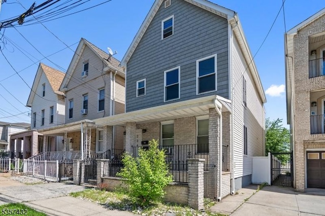 234 Lt Glenn Zamorski Dr, Elizabeth City, NJ 07206 - view of front of home with covered porch, a gate, and a fenced front yard
