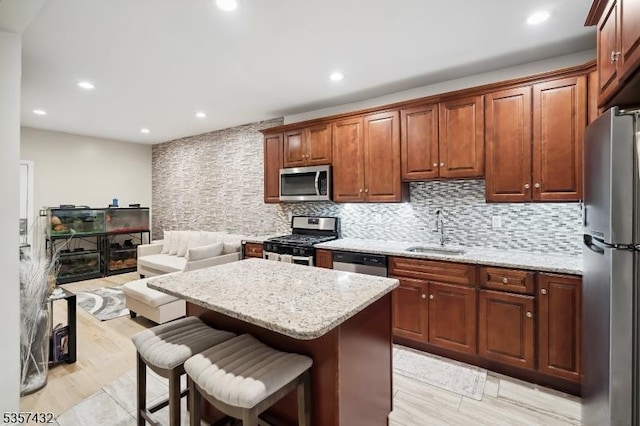 234 Lt Glenn Zamorski Dr, Elizabeth City, NJ 07206 - kitchen featuring stainless steel appliances, a sink, backsplash, a center island, and a kitchen bar