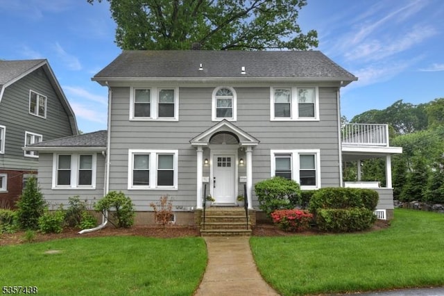 31 Wyckoff Ave, Wyckoff Twp, NJ 07446 - colonial inspired home with a front yard, a shingled roof, and a balcony