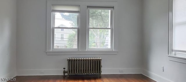 31 Wyckoff Ave, Wyckoff Twp, NJ 07446 - unfurnished room with radiator heating unit, dark wood-style floors, and baseboards