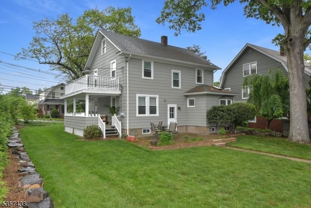31 Wyckoff Ave, Wyckoff Twp, NJ 07446 - back of property with a balcony, a chimney, a lawn, and a shingled roof