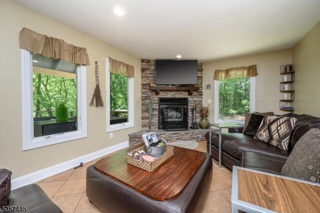 49 Sliker Rd, Lebanon Twp, NJ 08826 - living room with light tile patterned flooring, a stone fireplace, and baseboards