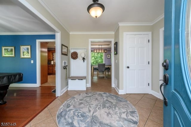 49 Sliker Rd, Lebanon Twp, NJ 08826 - entryway featuring light tile patterned floors, crown molding, baseboards, and a chandelier