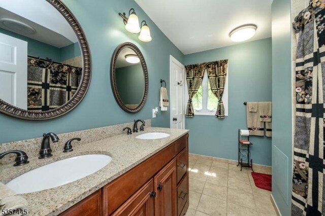 49 Sliker Rd, Lebanon Twp, NJ 08826 - bathroom featuring tile patterned flooring, double vanity, and baseboards