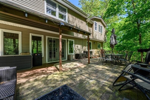 49 Sliker Rd, Lebanon Twp, NJ 08826 - wooden terrace with outdoor dining space and french doors