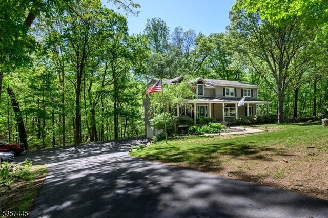 49 Sliker Rd, Lebanon Twp, NJ 08826 - view of front of home featuring a front yard, a porch, and asphalt driveway