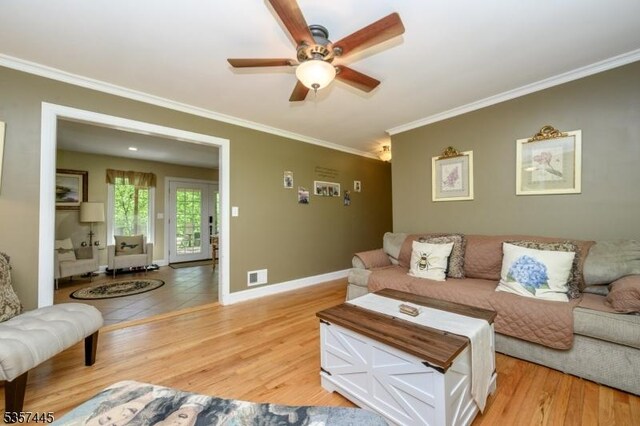 49 Sliker Rd, Lebanon Twp, NJ 08826 - living area with crown molding, a ceiling fan, light wood-style floors, and baseboards