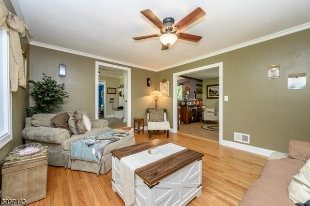 49 Sliker Rd, Lebanon Twp, NJ 08826 - living area featuring a ceiling fan, light wood finished floors, crown molding, and baseboards