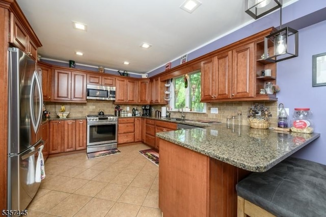 49 Sliker Rd, Lebanon Twp, NJ 08826 - kitchen with appliances with stainless steel finishes, a peninsula, open shelves, a sink, and brown cabinets