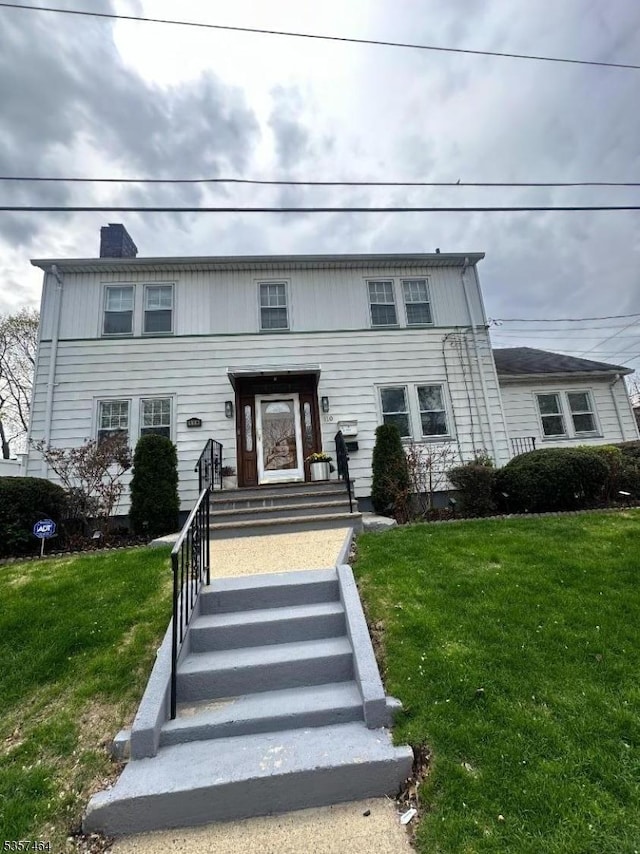 136 Nesbit Ter, Irvington Twp, NJ 07111 - traditional-style home with a front yard and a chimney