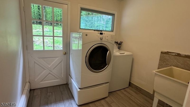 10 Deerpath Rd, Lebanon Twp, NJ 07830 - laundry area featuring separate washer and dryer, light wood-style flooring, a baseboard heating unit, and baseboards
