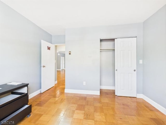 unfurnished bedroom featuring a closet and baseboards