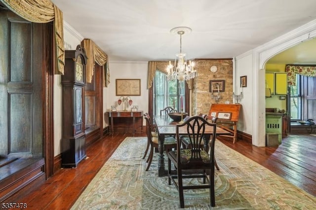 19 E Mill Rd, Washington Twp, NJ 07853 - dining space featuring a chandelier, dark wood-style flooring, arched walkways, ornamental molding, and baseboards