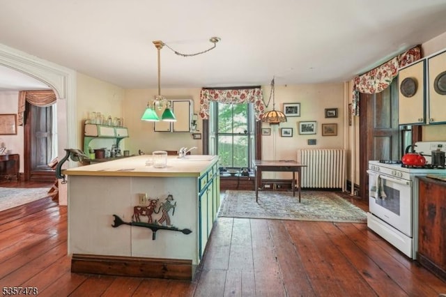 19 E Mill Rd, Washington Twp, NJ 07853 - kitchen with white range with gas stovetop, radiator heating unit, dark wood-type flooring, a sink, and a center island with sink