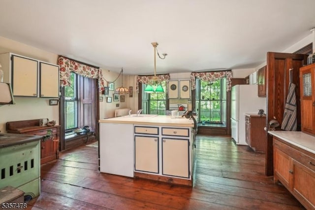 19 E Mill Rd, Washington Twp, NJ 07853 - kitchen featuring dark wood-style floors, freestanding refrigerator, decorative light fixtures, and light countertops