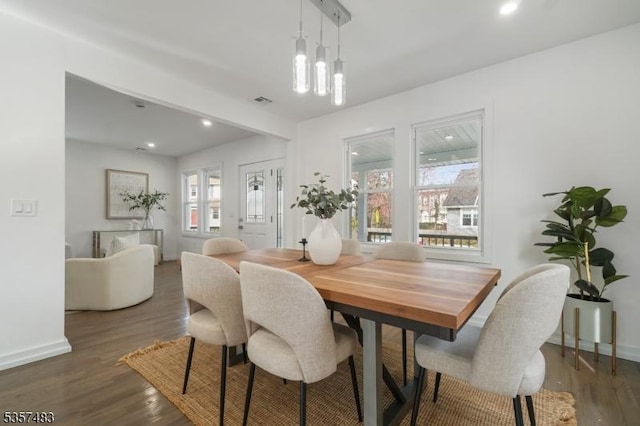dining space with wood finished floors, baseboards, and recessed lighting