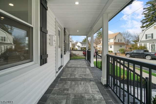 balcony with covered porch and a residential view