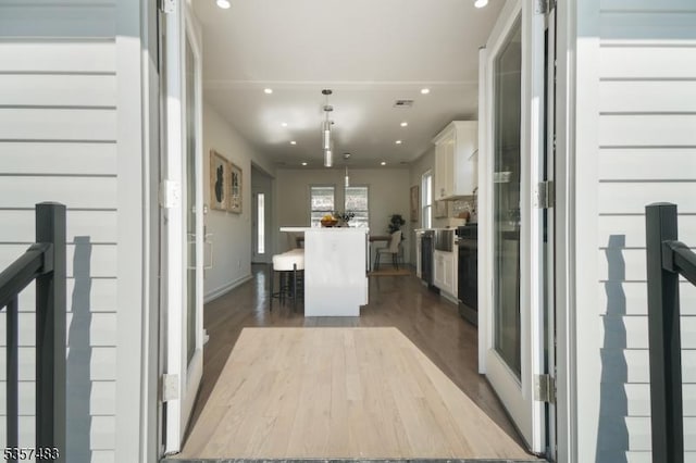 corridor featuring recessed lighting and dark wood-type flooring