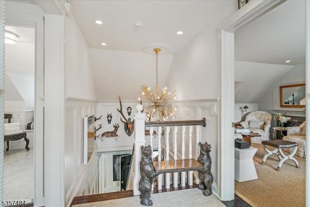 167 Lake End Rd, Rockaway Twp, NJ 07435 - hallway with lofted ceiling, a decorative wall, a chandelier, recessed lighting, and wainscoting