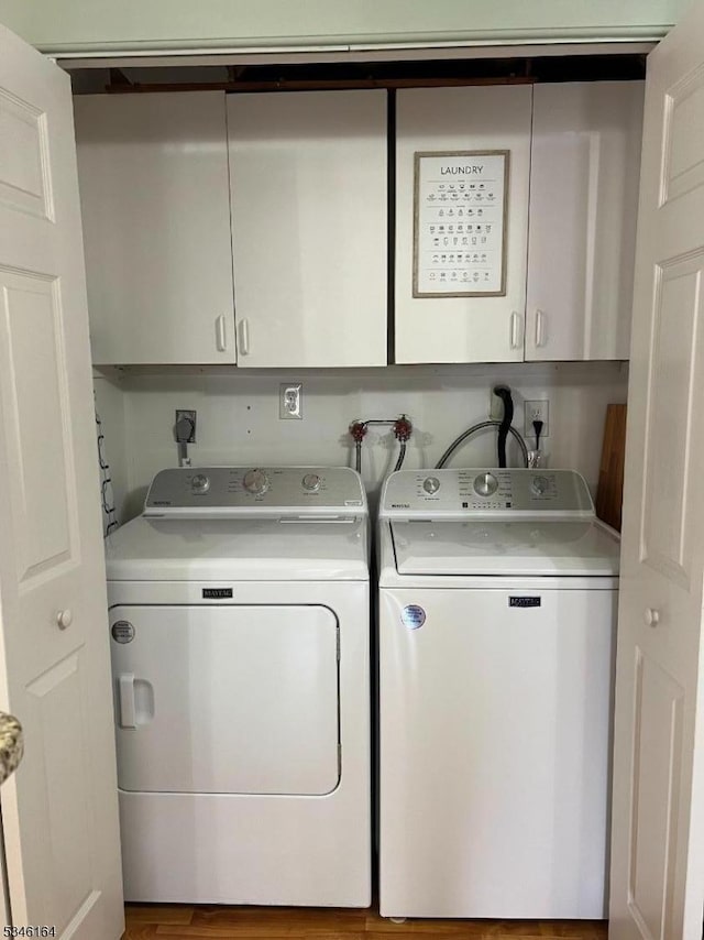 laundry area featuring washing machine and dryer and cabinet space