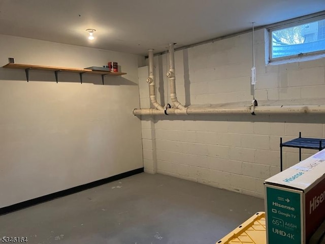 below grade area featuring concrete block wall