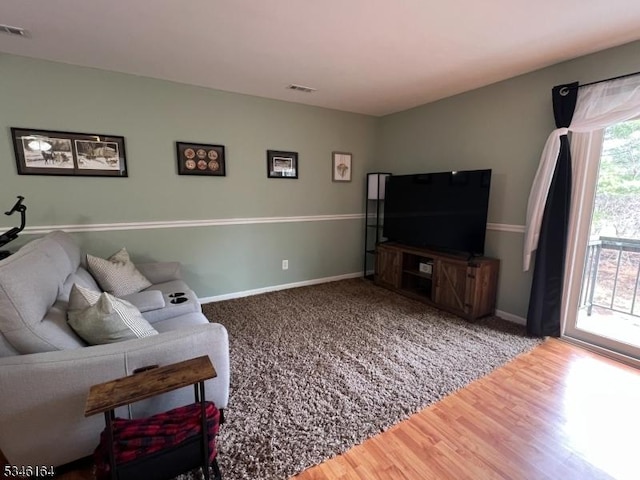 living room with wood finished floors and baseboards