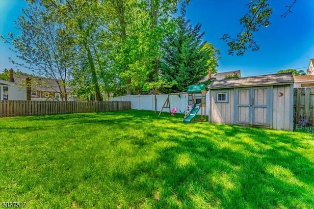 view of yard with a playground, a shed, and an outdoor structure