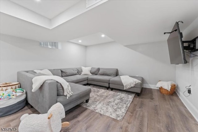 living area featuring wood finished floors, baseboards, and recessed lighting