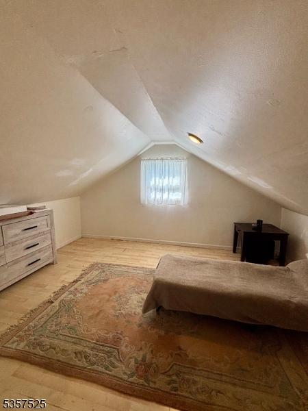 18 Park Dr N, West Orange Twp, NJ 07052 - bedroom featuring vaulted ceiling and wood finished floors