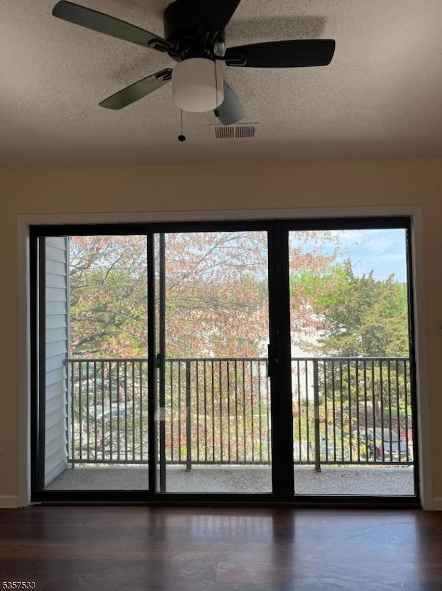 entryway featuring plenty of natural light, a textured ceiling, and ceiling fan