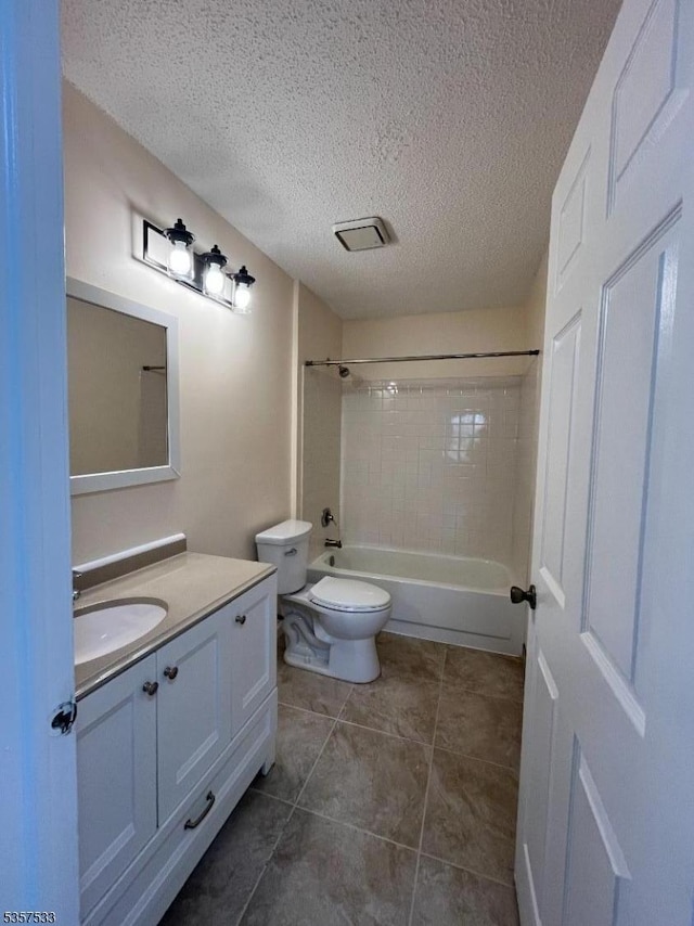 full bath with toilet, vanity, a textured ceiling, shower / bath combination, and tile patterned floors