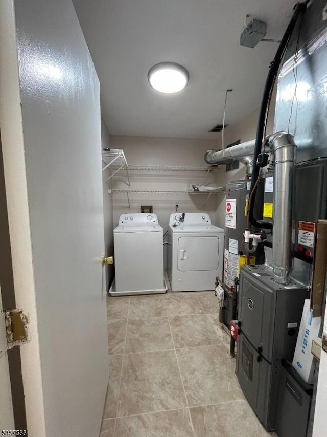 laundry room featuring separate washer and dryer and gas water heater