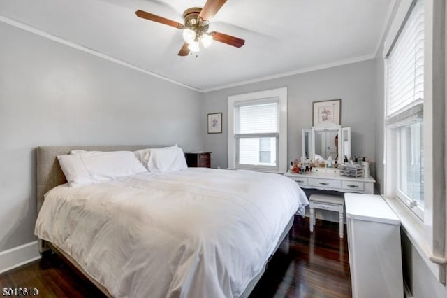 bedroom featuring dark wood finished floors, crown molding, ceiling fan, and baseboards