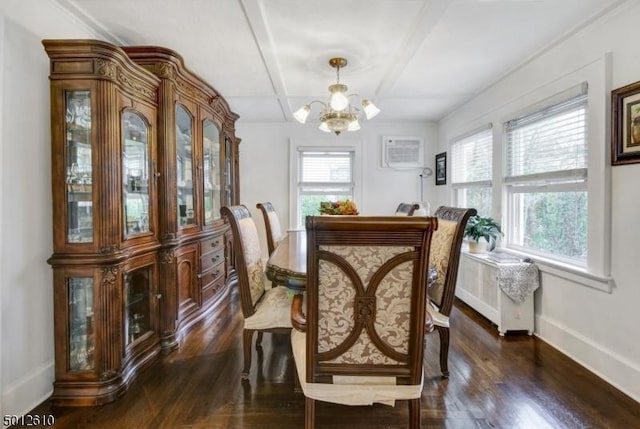 dining area with a chandelier, dark wood-style flooring, and baseboards